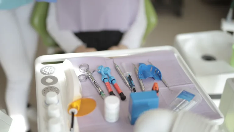 From above view of various modern medical instruments placed on tray near chair in modern room in clinic