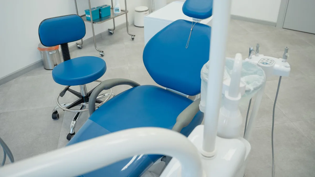 A clean and modern dental clinic featuring blue chairs and essential dental equipment.