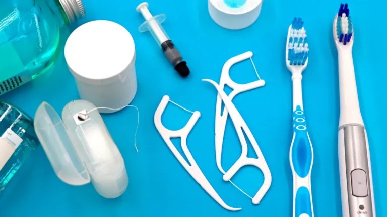 A variety of dental hygiene tools arranged neatly on a vibrant blue surface, showcasing oral care essentials.