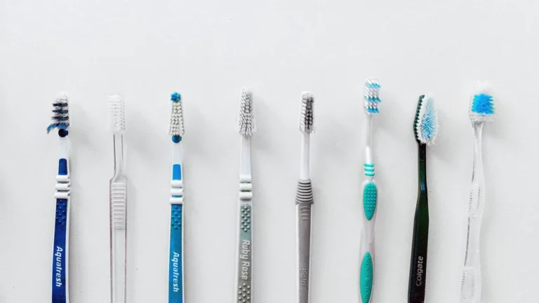 Diverse selection of toothbrushes lined up for dental hygiene focus with copy space.