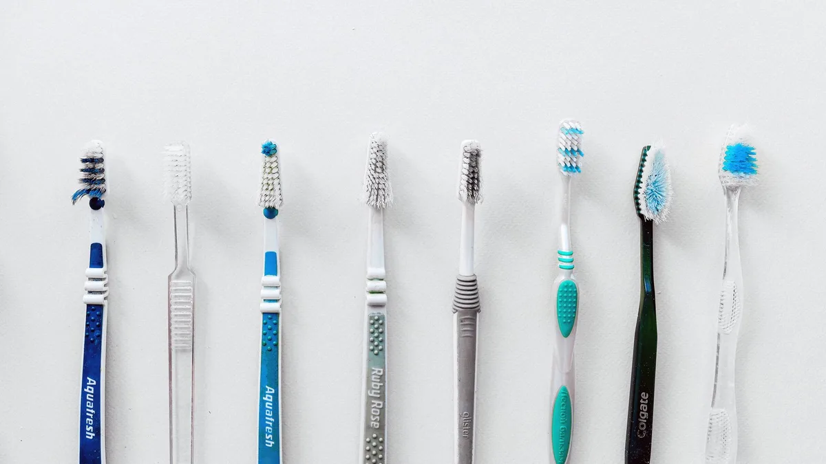 Diverse selection of toothbrushes lined up for dental hygiene focus with copy space.