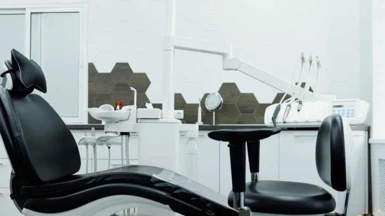 Clean and organized dental office featuring a modern dental chair and equipment.