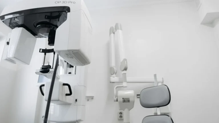 High-tech dental imaging equipment in a clean, white clinic setting.