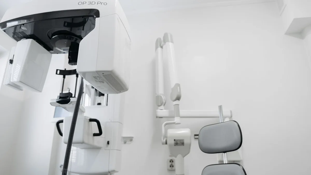High-tech dental imaging equipment in a clean, white clinic setting.
