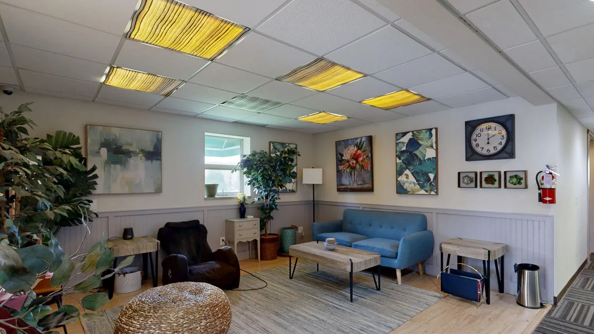 A modern lounge room with chic decor and ambient lighting, perfect for relaxation.