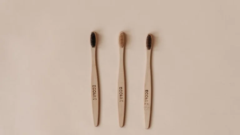 Minimalist flat lay of sustainable wooden toothbrushes promoting eco-friendly dental care.