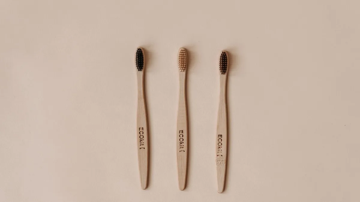 Minimalist flat lay of sustainable wooden toothbrushes promoting eco-friendly dental care.